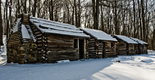 Jockey Hollow Log huts in snow